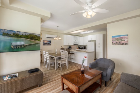 The fully equipped kitchen features modern appliances, a full-sized fridge, and ample counter space.
