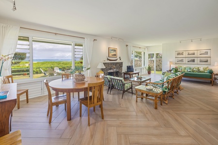 Relax in this bright dining area featuring elegant wooden furnishings and a stunning view, perfect for savoring meals and conversations.