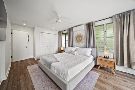 Airy bedroom with a king-sized bed, cozy textures, and serene garden views to create a restful retreat.
