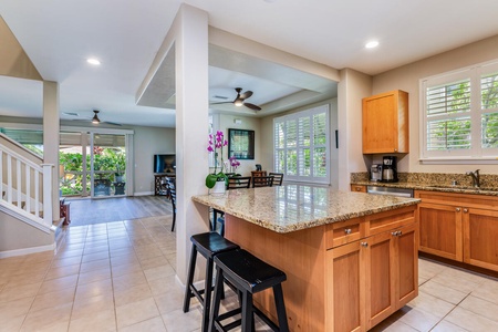 The kitchen features a spacious island bar with seating for two for quick meals and entertaining.