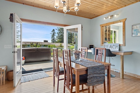 Dining area that opens up to the patio with an outdoor hot tub.