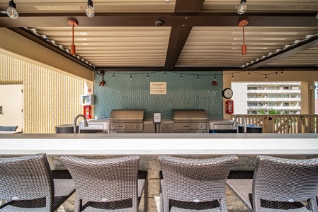 Covered outdoor shared dining area with stylish seating, ideal for enjoying meals in a shaded setting.