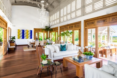 Open-concept living space with comfortable sofa, opening up to stunning outdoor views.