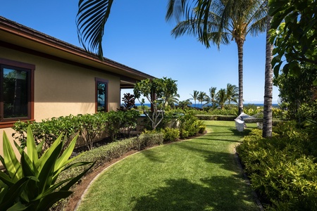 Closer view of side yard off guest bedroom two with hammock and ocean beyond.