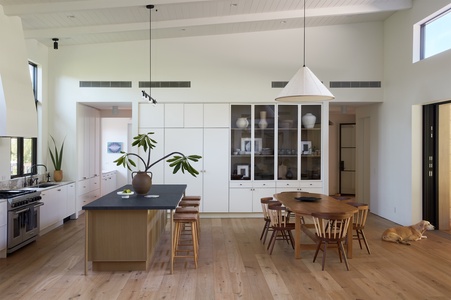 Gather with family and friends in this light-filled great room, where the kitchen, dining area, and living spaces come together with effortless flow.