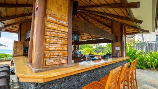 Savor tropical cocktails at the thatched-roof poolside bar, where ocean breezes and island flavors create your perfect vacation escape.