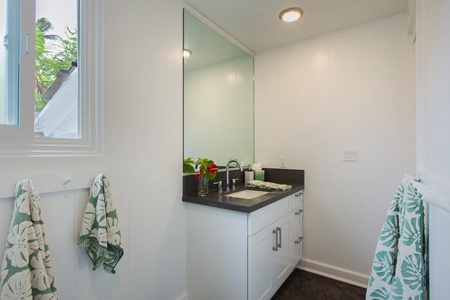Sleek and modern guest bathroom with polished finishes for a spa-like refresh after beach days.