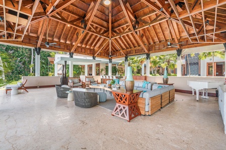 Spacious open-air lounge with vaulted wooden ceilings, perfect for unwinding in style.