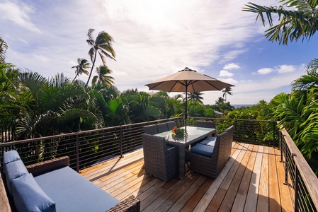 Sip your morning coffee on this stunning deck surrounded by swaying palms and tropical views.