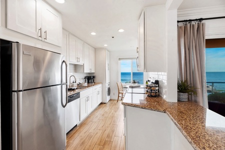 The updated kitchen features European design and all new appliances, including a washer/dryer tucked away near the breakfast nook.