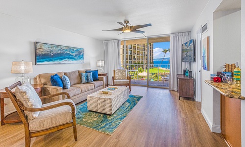 Relax in the comfortable living room with direct access to the lanai, offering beautiful views of the ocean and resort grounds.