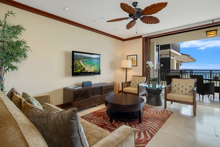 Cozy living room framed by tropical décor and ceiling fan.