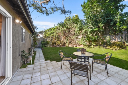 Separate gated entrance from driveway and recently installed artificial turf.