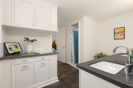 Spacious primary bathroom with dual vanities, vibrant accents, and a walk-in shower—ideal for relaxing into your extended island stay.