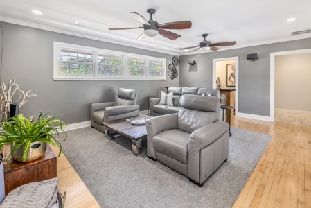 Media room with plush leather seating, great for movie nights or gaming.