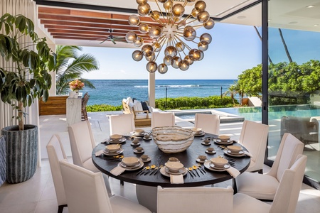 Host memorable dinners at the grand dining table while the ocean horizon enhances every meal.