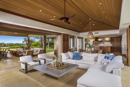 The elegant great room opens to the lanai, offering expansive views & an indoor/outdoor living experience
