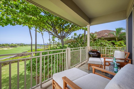 Covered lanai with plush seating and panoramic golf course views—your private slice of paradise.