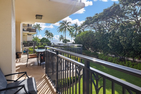 Your private balcony offers a serene tropical escape with swaying palms, lush greenery, and glimpses of the sparkling ocean—perfect for sipping morning coffee or unwinding under the island sun.