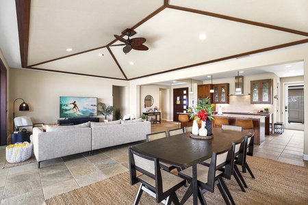 Vaulted ceilings, central A/C, and a ceiling fan create a cool and inviting dining and living space.