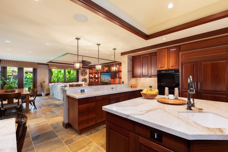 Vaulted wood-inlay ceilings and pocket doors create seamless indoor-outdoor living.