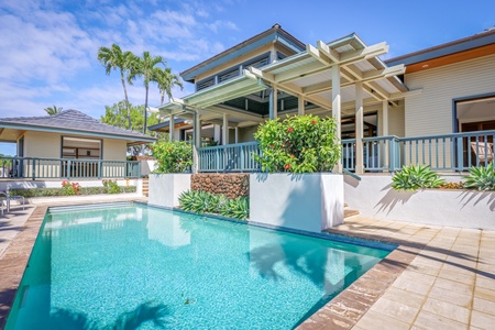 Back of this property showcasing the private pool, warmed naturally by the sun, and multiple wrap-around lanais to soak in the views