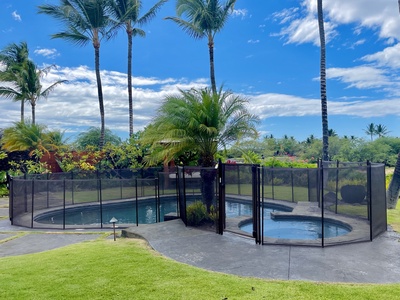 View of the pool & spa with a Child Safety fence that can be set up upon request (Set-up fee applies)