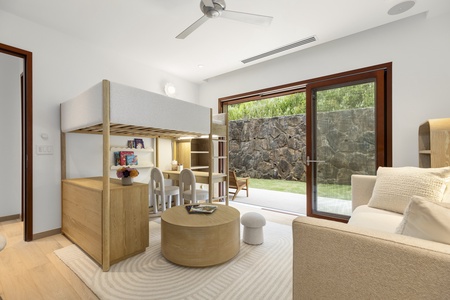 Guest bedroom lounge with large windows and mountain views, a quiet spot for reading or relaxing.