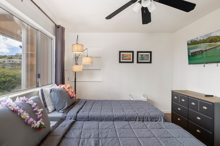 Comfortable and private, this guest suite includes ceiling fan, storage, and natural light—well suited for a sitter, teen, or remote office.