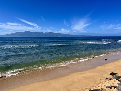 Enjoy a drink on the lanai at Kaanapali Shores 213, with views of the pool and lush scenery.