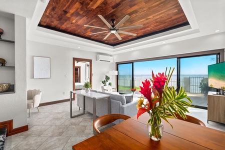 Dining area with seating for 4, featuring a vibrant floral centerpiece and warm wood accents.