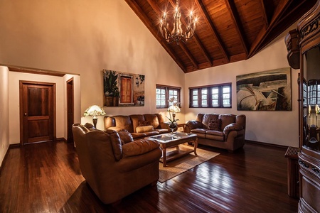 Gather or relax on the cozy living space, with leather seating, warm lighting, and high wooden ceilings.