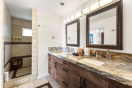 Refresh in a spa-like bathroom with dual vanities and a spacious walk-in shower.
