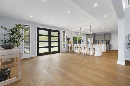 Front entry doors leading into a large foyer with open kitchen.