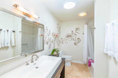 The second bathroom features a tub and charming décor, perfect for family-friendly convenience.