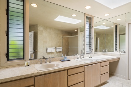 Spacious ensuite with dual vanities and a large mirror—perfect for a relaxed start to your day.