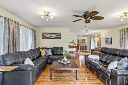 The living space flows effortlessly with natural wood floors, ideal for families or groups enjoying time together.