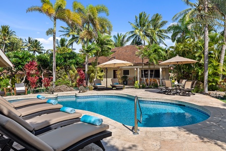 Resort-style pool area with loungers and umbrellas for ultimate relaxation in the sun.