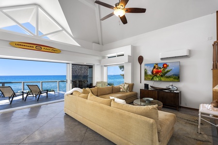 Spacious great room opens to the lanai with vaulted ceilings and wall-to-wall ocean views.