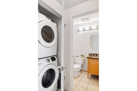 Powder room beside the stacked washer-dryer keeps beach gear fresh and quick pit stops easy.