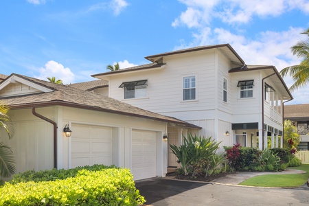 Outside view of the two-story home with a spacious garage and lush landscaping.