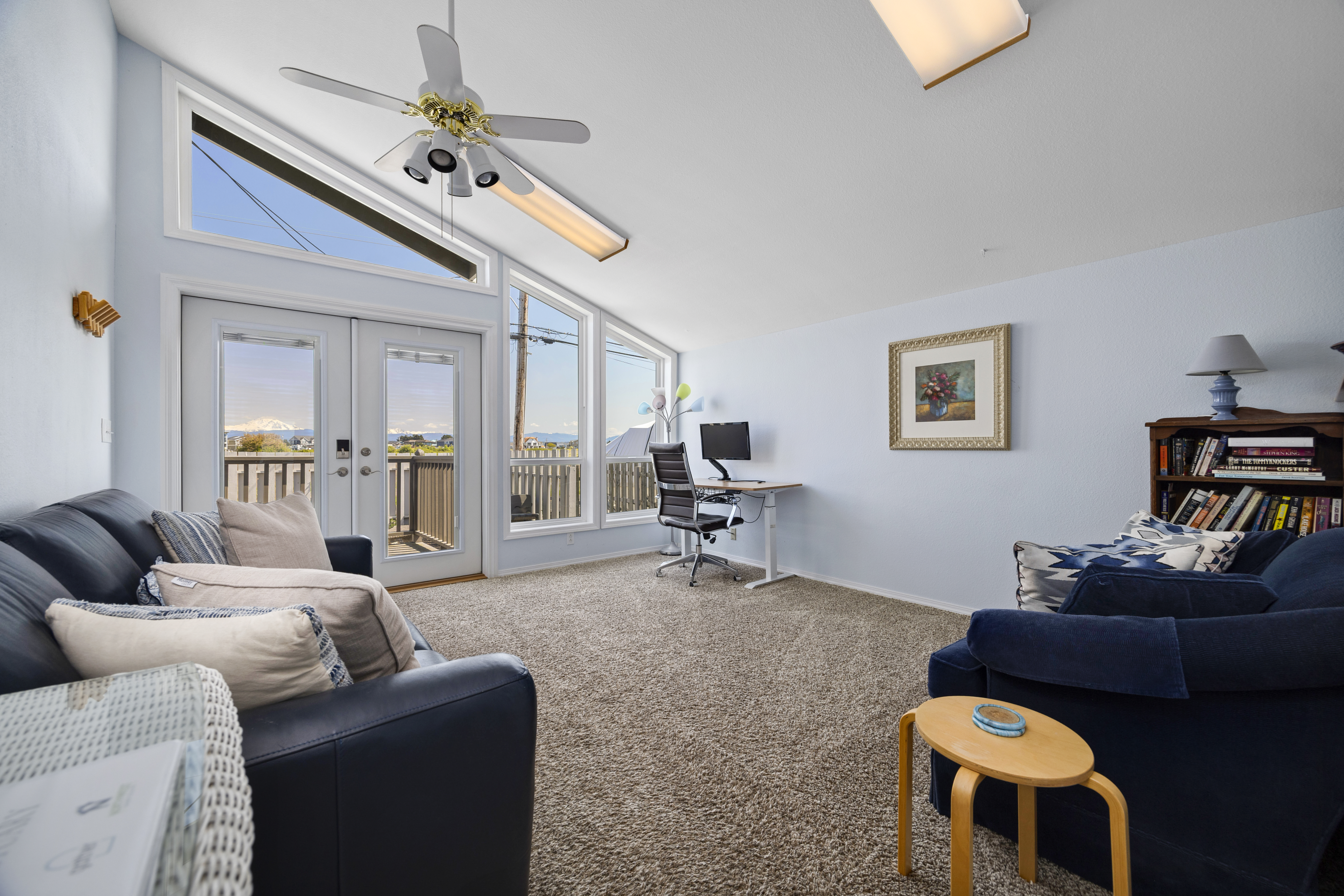 The front sitting area offers stunning water views and includes a queen sleeper sofa for extra guests.