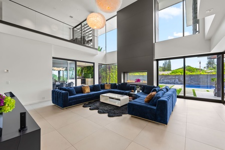 Gather beneath soaring ceilings and oversized windows in the main living room—ideal for both connection and quiet reflection.