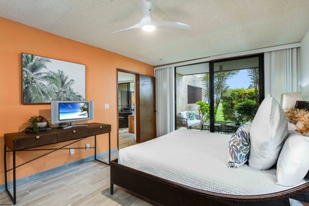Unwind in the primary bedroom with serene views and direct lanai access—ideal for a peaceful retreat anytime of day.