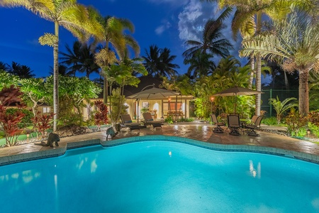 Sparkling pool surrounded by lush tropical landscaping, perfect for relaxation.