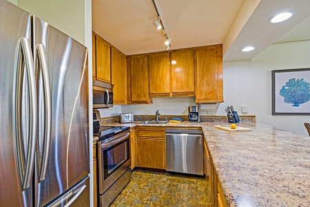 The kitchen at Kaanapali Shores 544 features modern appliances and ample space for family meals.