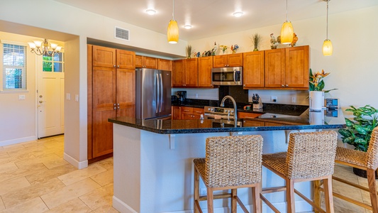 The open floor kitchen with breakfast bar seating.