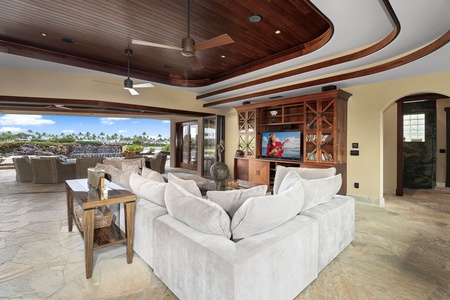 Unwind in the inviting living area with plush seating and a rich wood-paneled ceiling.