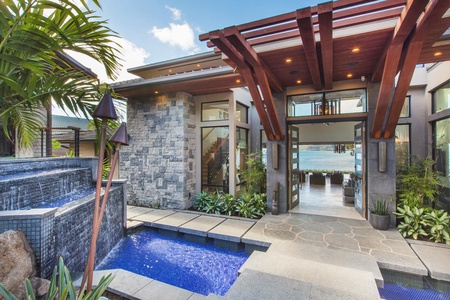 Striking front entrance with floating steps and oversized doors, setting a dramatic first impression.