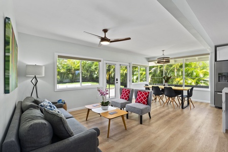 Bright and airy, this open-plan living space seamlessly connects the lounge area to the dining room, highlighted by natural light and stylish furnishings.